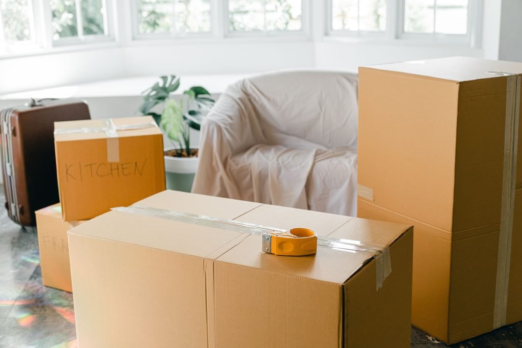 Packed moving boxes in a bright, sunlit room