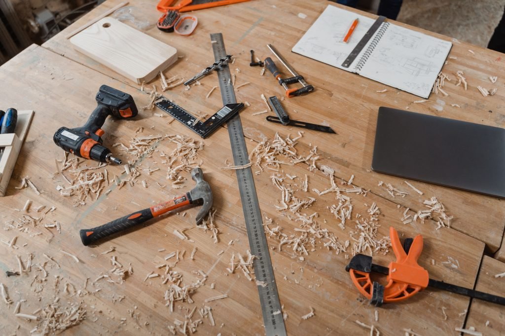 Carpentry and repair tools laid out on a workbench