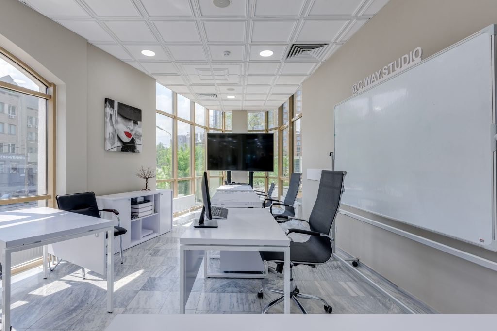 Modern office with white desks and black rolling chairs